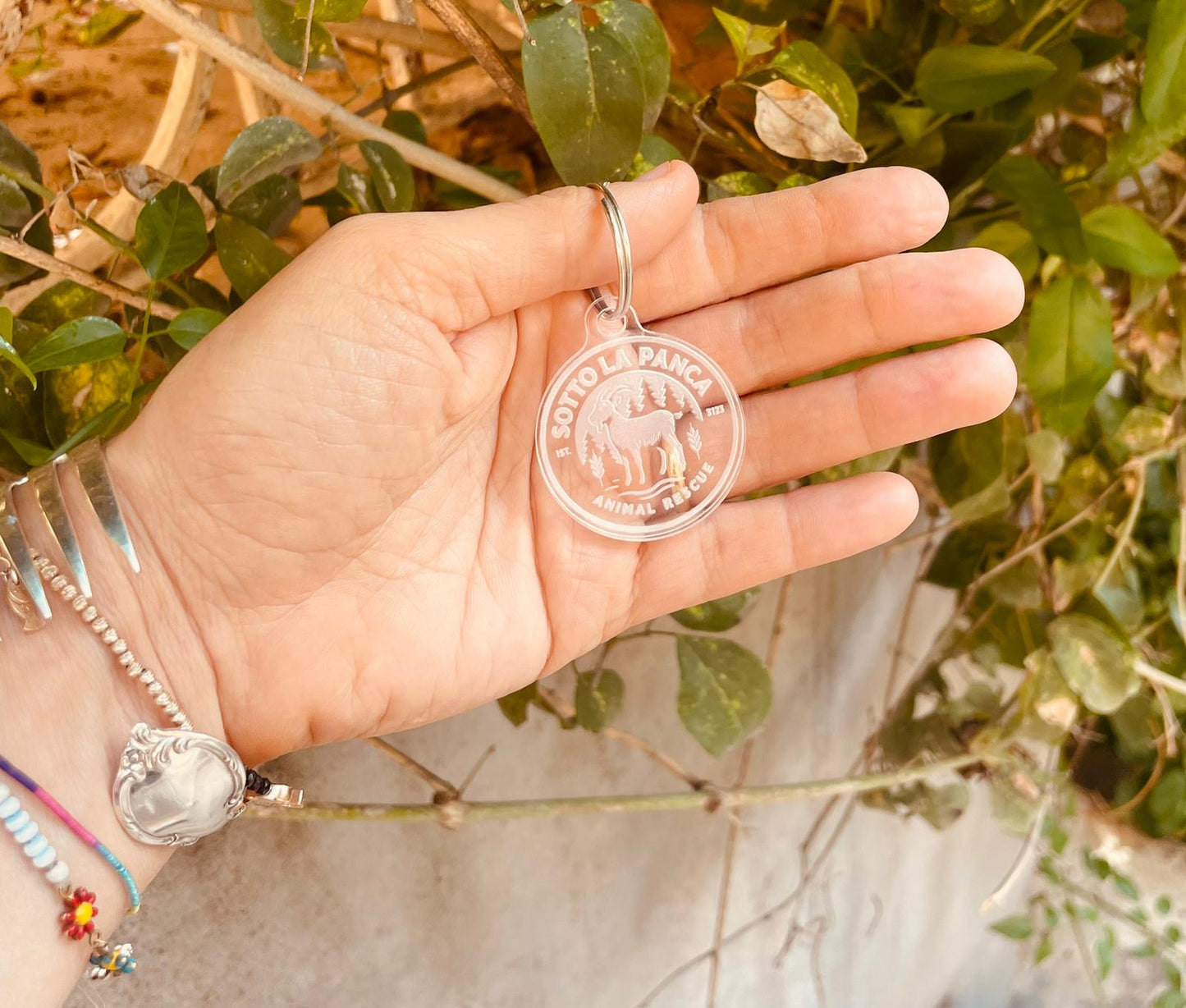 Solidarity Keychain with Sanctuary Sotto la Panca Logo